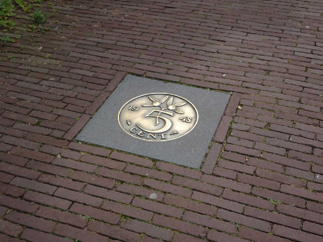 A giant coin in the pavement.
