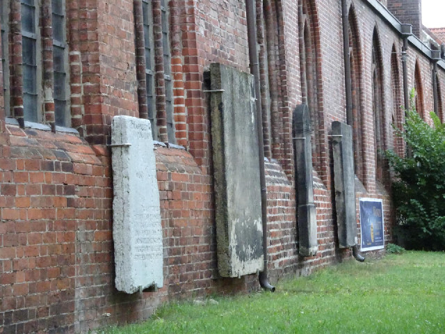 The church has some very worn stone slabs attached to the outside.