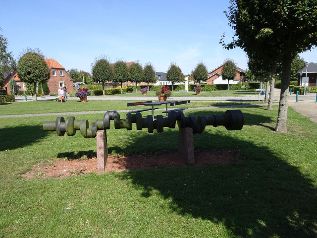 A big crank shaft on display in a park outside the H Christoffersen diesel engine factory.