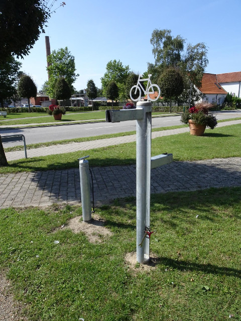 The short pole is an air pump. The tall one looks like it is designed to hold bikes and has a select...
