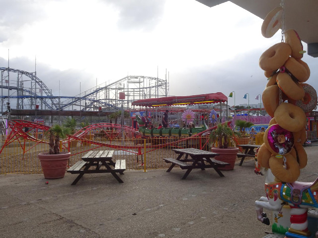 A very small roller coaster, and a stall whose prizes are cuddly doughnuts.