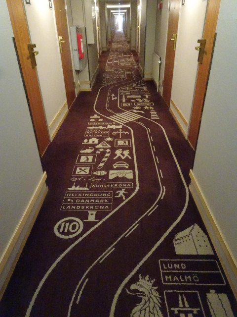 The corridor carpet has a road theme.