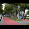 This road is painted pink and has many signs saying that it's a bicycle road, and just a few other l...
