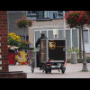 The UPS bike has a box on the front and another on a trailer.