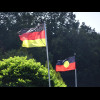 The German flag and the Australian Aboriginal flag flying outside a restaurant.