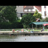 The lake in the previous picture includes a small lido. In this picture, the boy in green shorts is ...