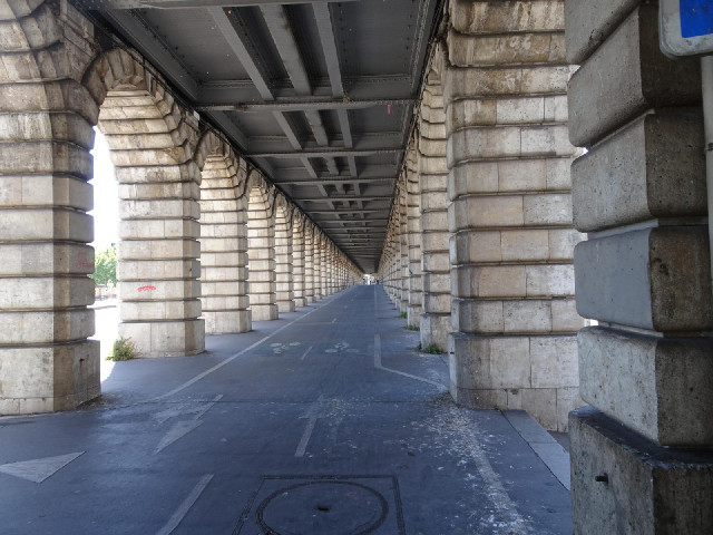 The Pont de Bercy has a railway on the top deck, roadways along the sides and this bike path through...