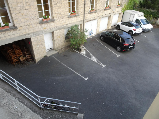 The view from my room, including my bike and a big pile of old chairs.