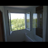 The room is airy because it has fully-opening windows like this, with a river view, in both the bedr...