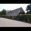 A thatched house. Its garage is similar.