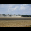 A tractor kicking up dust.