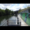 This metal bike path is mounted onto the side of a road and hangs over the river. It's only just wid...