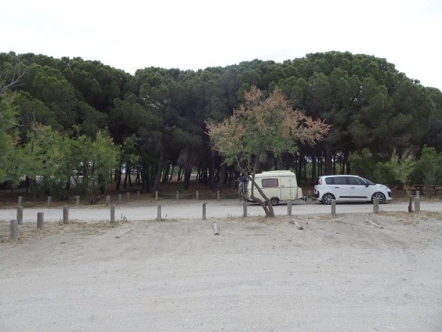 A sandy car park.