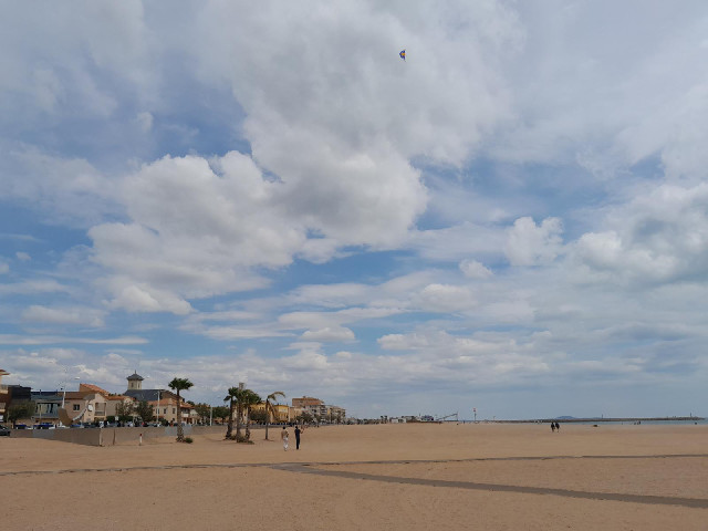 Some people flying a kite.