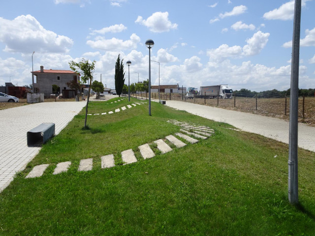 A well-watered grassy mound with three twisty paths over it.
