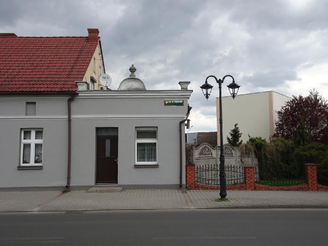 There is an old lamp-post next to the sign.