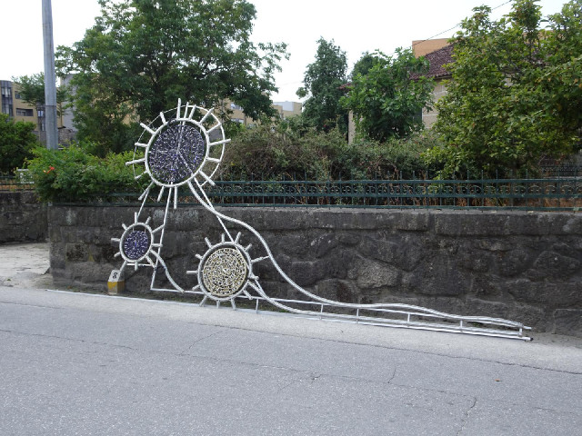 Decorative lights either on their way up or on their way down. Later, in a small village, I would dr...