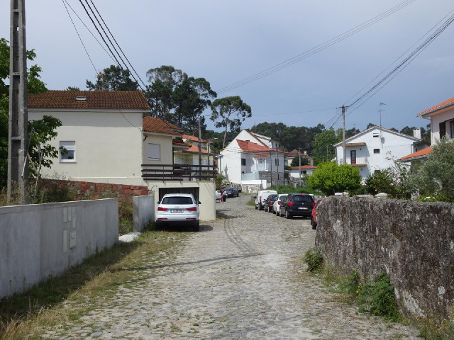 2nd of July Road in Monte da Ola. The road heads towards the school, where there is a party going on...