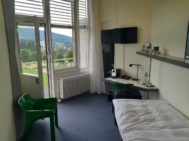 The room is a wedge of a circle so it's an unusual shape. The bathroom is aginst the outside wall an...