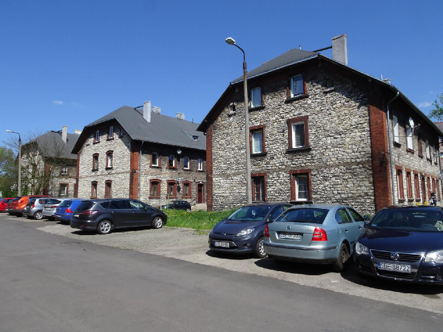 Three of the large buildings at the top of 3rd April Street, seen from the back because the sunlight...