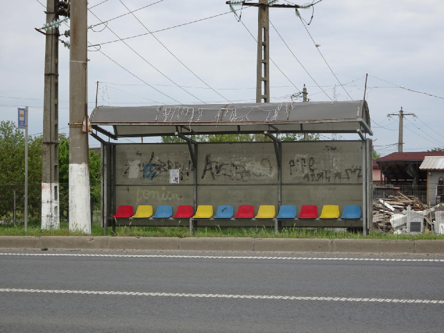 The seats in the bus shelter are in the national colours.