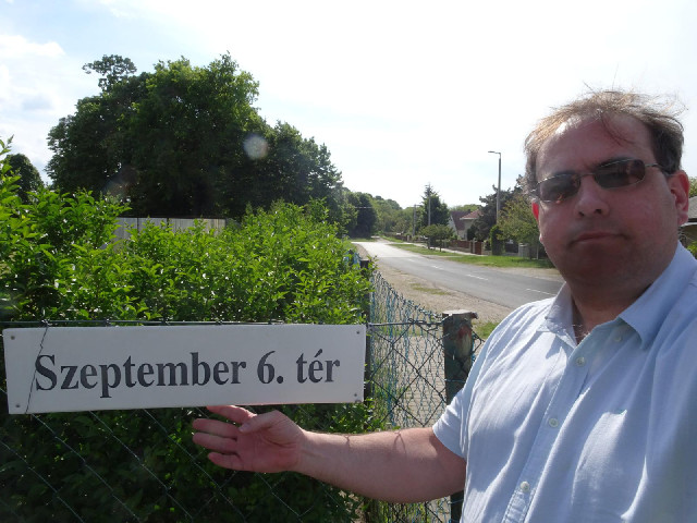 The bushes and trees on the left are in 6th September Square.
