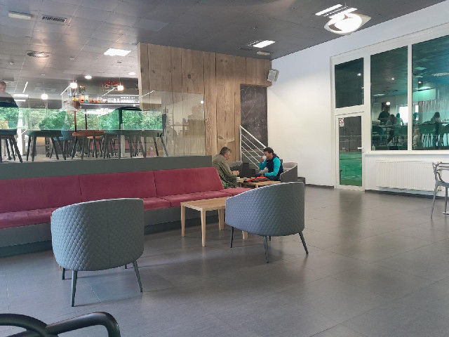 This is the breakfast room of my hotel. Through the window on the right I can see people playing bad...