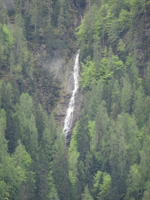 A waterfall high up a mountainside.