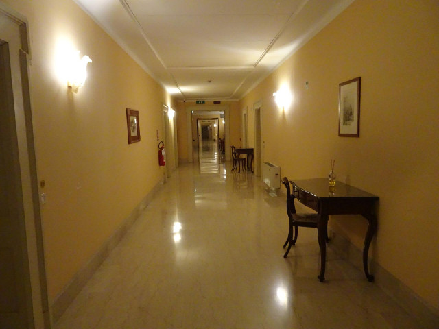 The desks in the corridors here look less welcoming than those in this morning's hotel. Why would an...