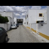 26th of February Road in Evora. The house on the right has several large bottles of water lined up o...