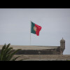 A flag flying on a coastal fort.