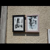 The first house in the road has some old photographs on it.