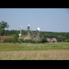 Some Belgian farm equipment, and a mobile phone tower.