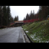 Snow is starting to appear as I continue to climb. I think that's a ski piste crossing the road. I h...