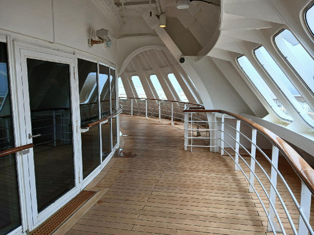 The promenade on deck 7 goes right round the ship. Here it is going round the bow. The room behind t...