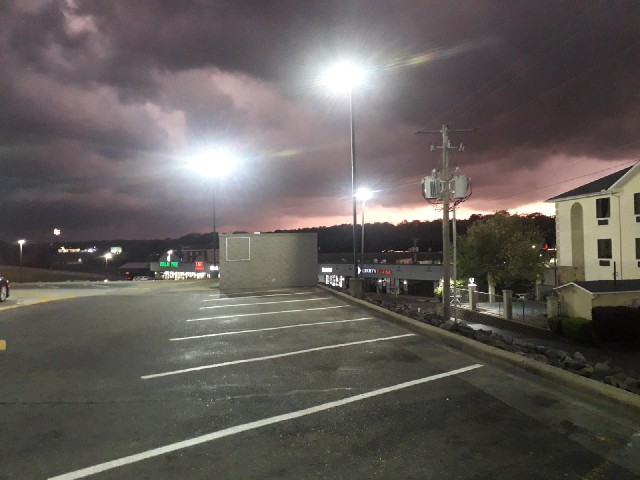 The sky just above the trees shows how light it would normally be at this time but thick black cloud...