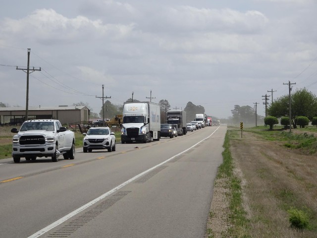 A traffic jam caused by three tractors.