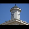 What looks like it should be a clock tower instead has pictures of a blacksmith within the outline o...