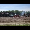 A scrapyard where something is working hard, producing a lot of smoke.