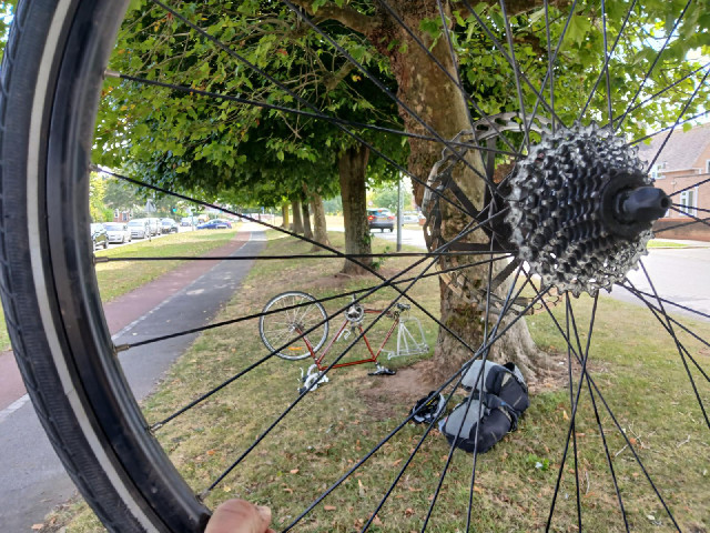 It's hot and sunny already so I rode on until I found this shady place for replacing the spoke, whic...