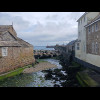 Looking along Newlyn harbour wall. The small red and white hut at the base of the lighthouse contain...