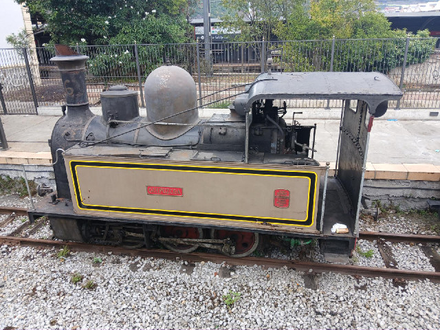 An old tank engine. Out of the shot are a few historic wooden carriages and another cyclists who has...