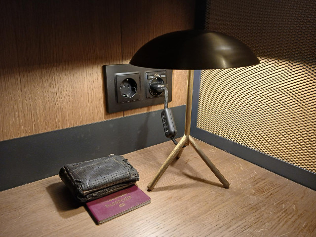 The desk has a very small lamp.
