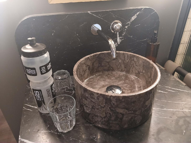 I won't be able to get my water bottles under that tap but at least there is a proper glass to drink...