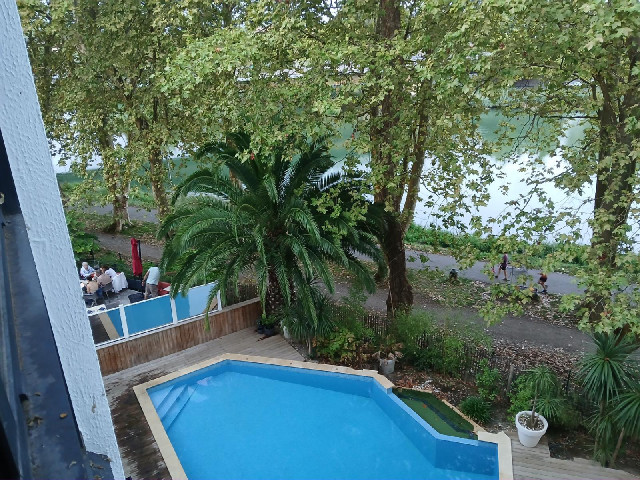 Tonight, my view is of the pool, part of the terrace of the restaurant, which closes at half past ni...