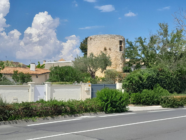An old stone tower in somebody's garden.