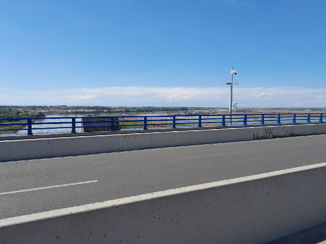 Looking West, the sky and the river are both blue.