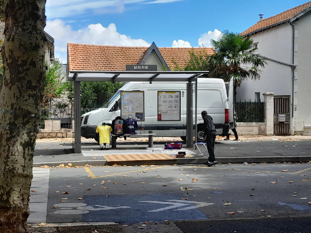 The main street is closed for the market. Somebody here is using a bus shelter as a stall.