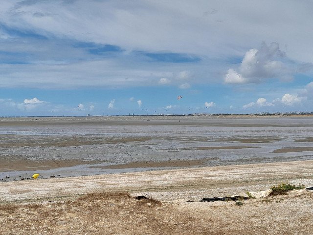 Kite surfers with La Rochelle in the background.