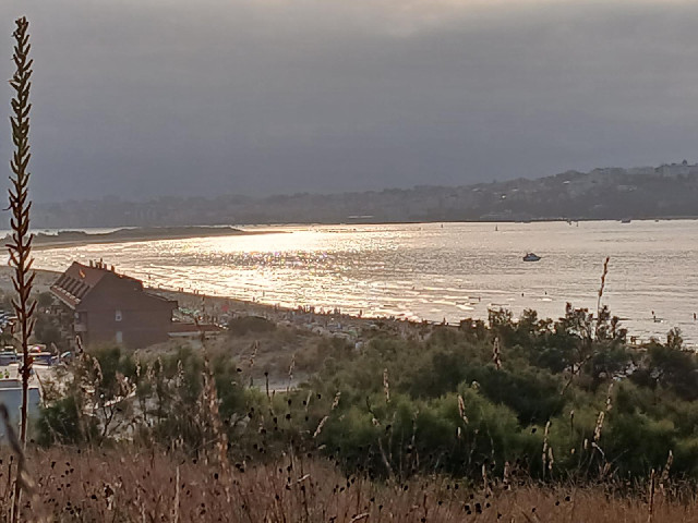 Partially-eclipsed sunlight on Somo Beach.